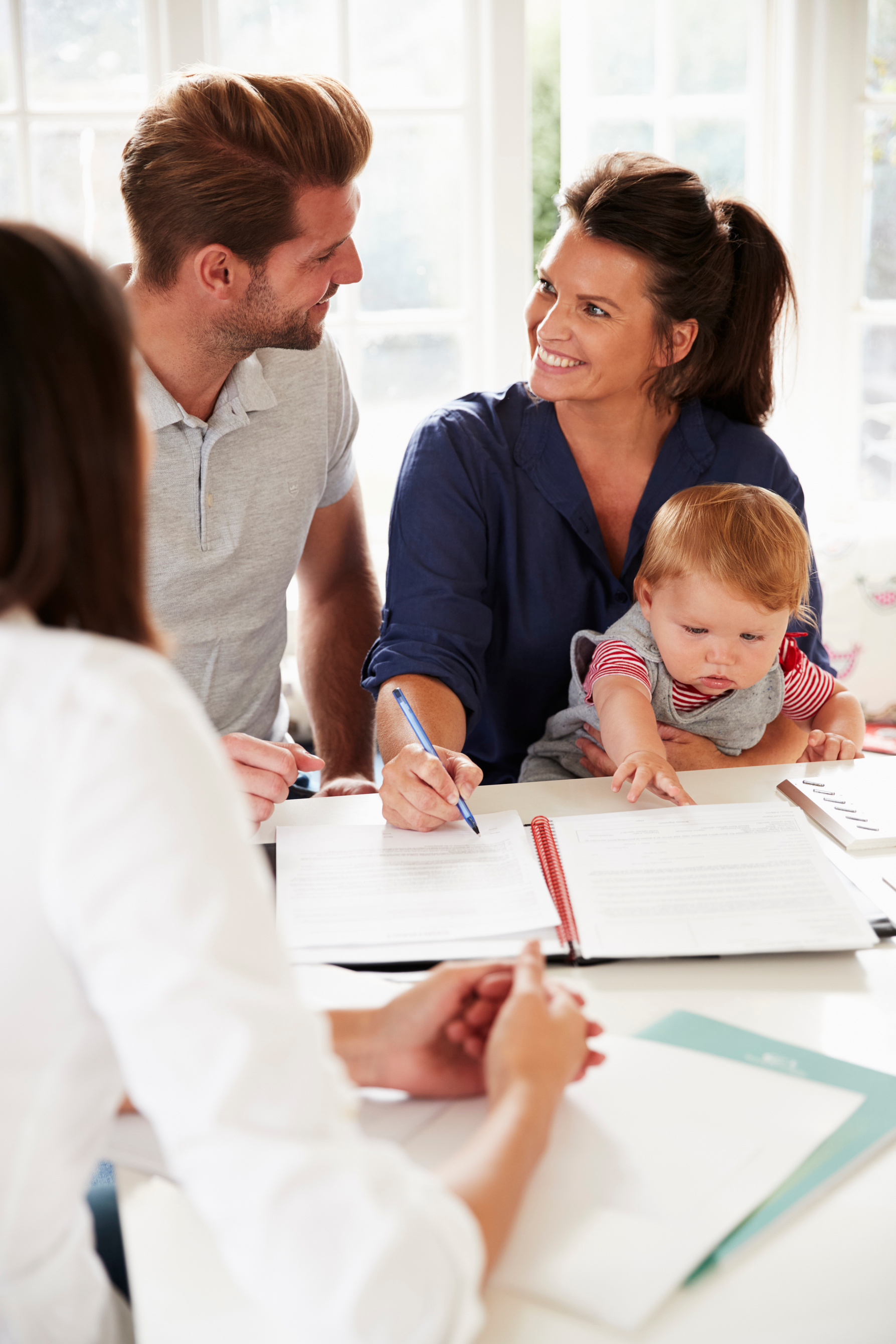 Family with Baby Meeting Financial Advisor at Home